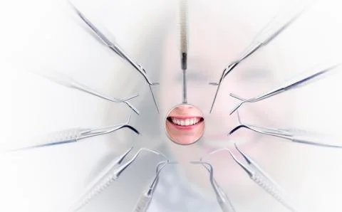 Dentist mirror with reflection of woman's teeth and dentist tools Stock Photos