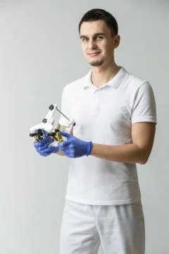 Dentist with parallelometer Stock-Fotos