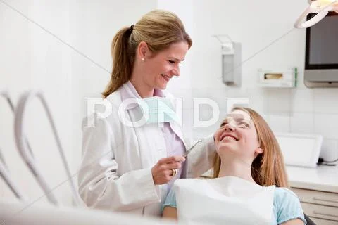 Dentist With Patient In Surgery