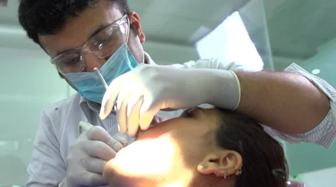 Dentist performing surgery using sterilized equipment. Portrait of  Stock Footage 68293123