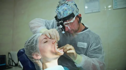 A dentist performs dental procedures in a clinic using special instruments Stock Footage 342079774