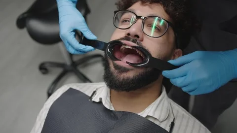 Dentist performs procedure on patient in clinic with focus on oral care Stock Footage 320874917