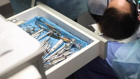 Dentist performs root canal with dentistry tools Stock Footage 120764907