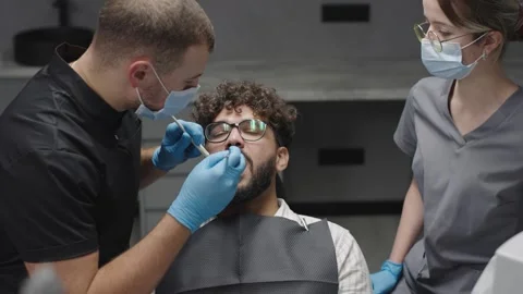 Dentist performs routine checkup with patient in clinic setting Video stock 320877902