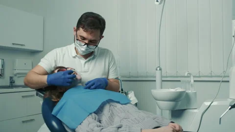 Dentist performs a teeth whitening procedure. A beautiful smile Stock Footage 152244379