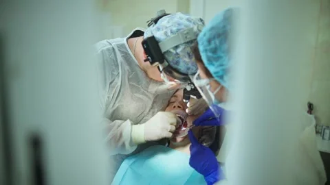Dentist places of the parallel post in the jawbone before placing the implant Stock Footage 342079816