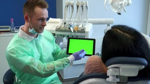 Dentist points his hand on tablet screen Stock Footage 311984552
