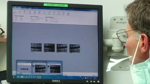 Dentist points to X-ray on computer screen Stock Footage 8653023