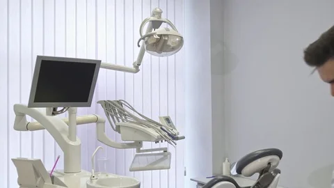 Dentist poses at the office Stock Footage 76518496