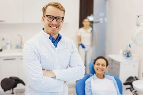 Dentist posing at camera with patient Stock Photos