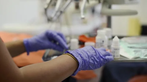 Dentist prepares solution for seals Stock Footage 136973688