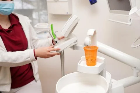 The dentist prepares for work and sets up the remote control for examining te 写真素材