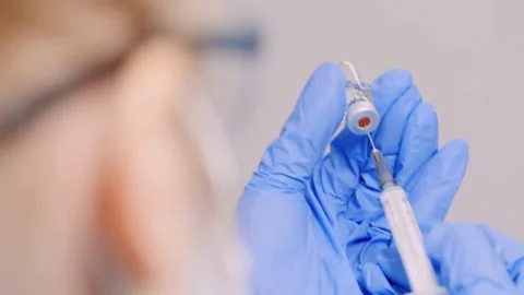 Dentist preparing to administer local anesthetic to patient Wear a mask and Stock-Footage 336586946