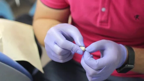 A dentist is preparing a dental prosthesis for prosthetics Stock Footage 72277377