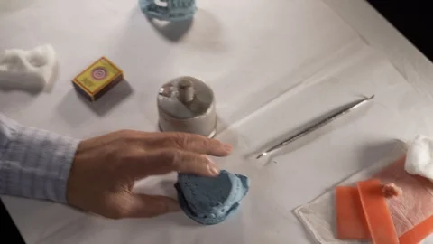 Dentist preparing denture cast with modelling wax for RPD, medium shot Stock Footage 108112856