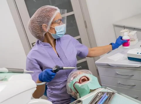 Dentist preparing ultrasonic device Stock Photos