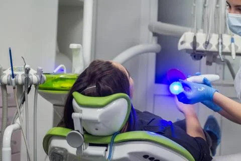 Dentist preparing ultraviolet light before making dental fillings. Stock Photos