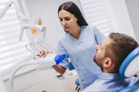 Dentist preparing uv lamp to procedure Stock Photos