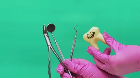 Dentist Presenting Dental Instruments and Painful Tooth Model Stock Footage 337106416