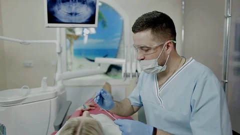 Dentist professional working with patient by using special tools in dental Stock Footage 104349908