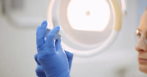 Dentist prosthetics looking at denture or jaw cast Stock Footage 125490784