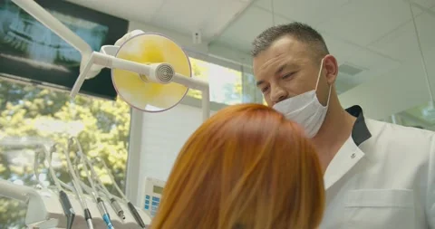 The dentist pulls on the mask close up. Caucasian Arabic appearance Video stock 136960279