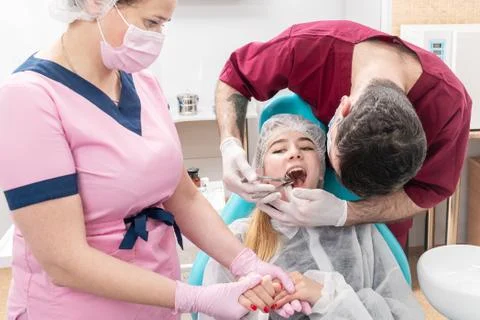 Dentist pulls out a tooth Stock Photos