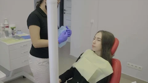 Dentist puts on the patient's head the cap of hair before the operation. Stock Footage 127824844
