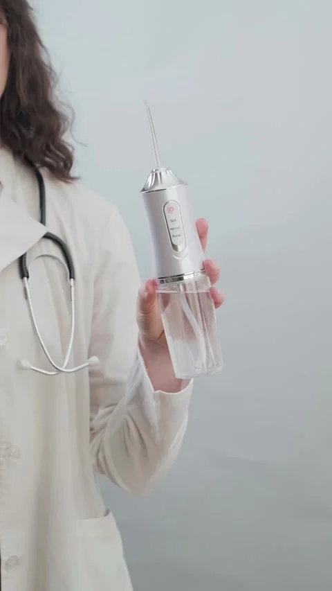 Dentist recommends using an irrigator for daily care and prevention of oral Stock Footage 307303077