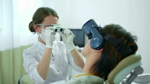 Dentist regulates special glasses before work Stock Footage 120443388