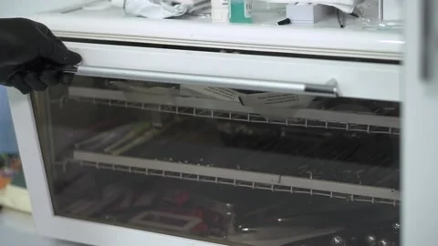 Dentist removes sterilized instruments from a bactericidal lamp 動画素材 130854675