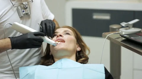 Dentist scanning the teeth of patient with a d scanner Stock Footage