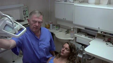 Dentist sets up its projector Video stock 52945149