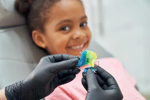 Dentist showing braces for improving bite. Stock Photos