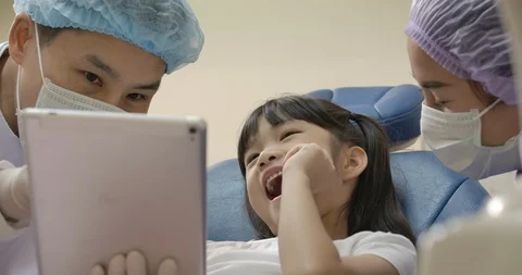Dentist showing teeth x-ray image to patient. Stock Footage 118083289