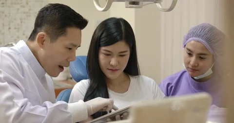 Dentist showing teeth x-ray image to patient. Video stock 118084502