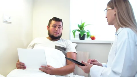 Dentist showing X ray scans to patient in clinic Stock Footage 140752104