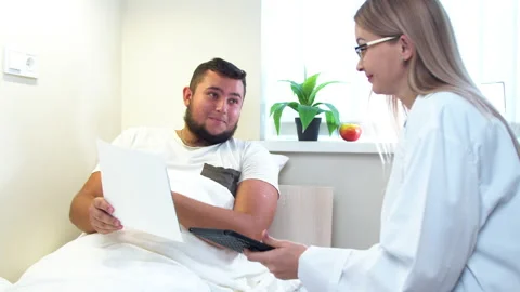 Dentist showing X ray scans to patient in clinic Stock Footage 140755331