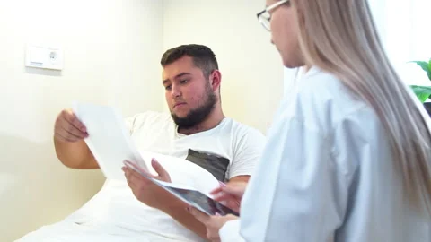 Dentist showing X ray scans to patient in clinic Stock Footage 140763692