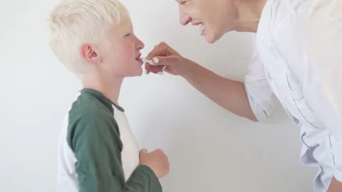 The dentist shows the boy the blonde how to properly brush his teeth. Stock Footage 134667772