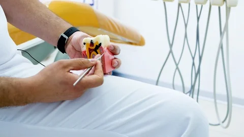 The dentist shows how a broken teeth with caries, a lesson Stock Footage 104294030