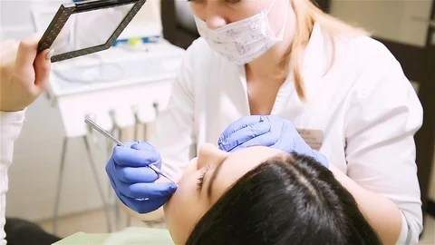 The dentist shows the patient his problem Stock Footage 112532273