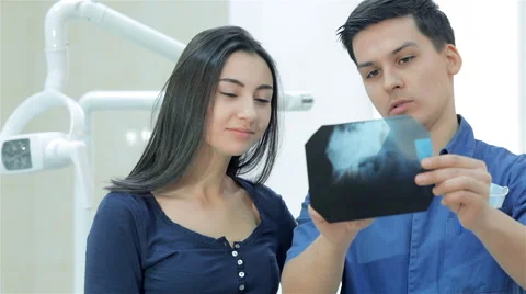 Dentist shows a patient x-rays of the teeth Stock Footage 45852844