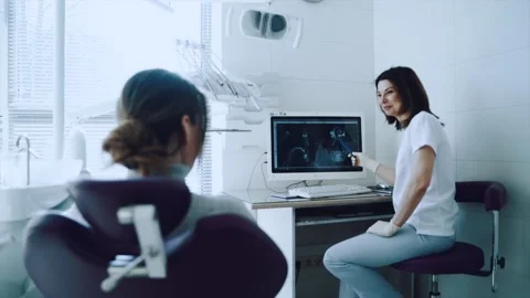 The dentist shows the X-ray on the computer Stock Footage 163890898