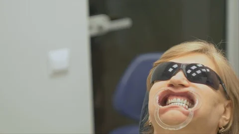 The dentist in a special computer program loaded into the tablet checks and Stock-Footage 88322609