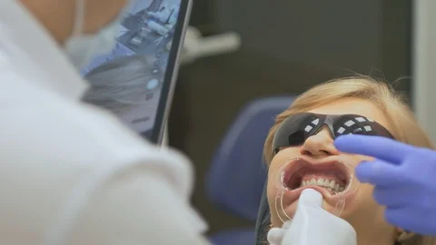 The dentist in a special computer program loaded into the tablet checks and Stock-Footage 89222563