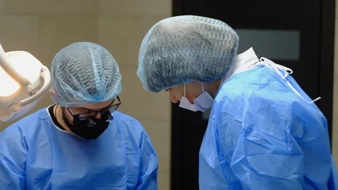 The dentist surgeon performs an implant placement operation Stock Footage 124574969