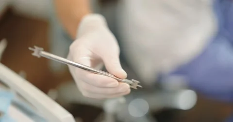Dentist taking dental tools during a medical treatment Stock Footage 147885214