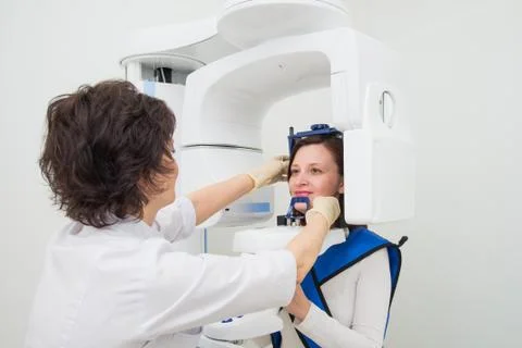Dentist taking a panoramic digital X-ray of a patient s teeth Stock Photos