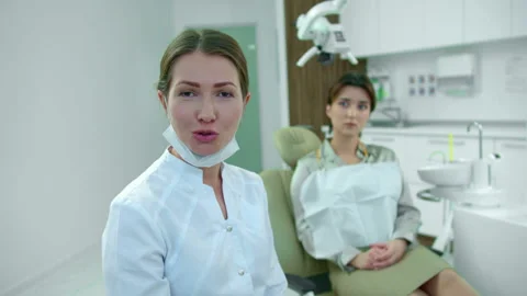 Dentist talks on camera in cabinet in slow motion Stock Footage 120450348